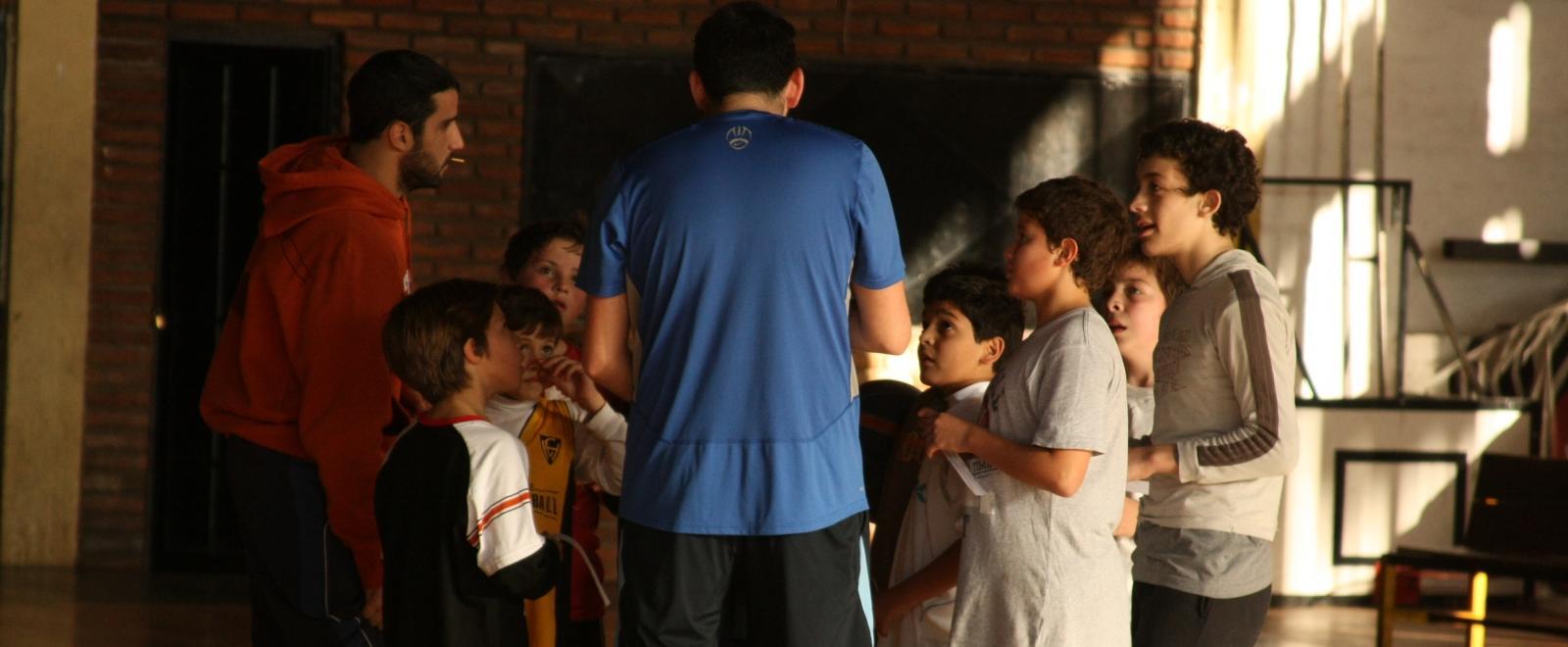 A sports player meets with his team as part of his volunteer sports coaching in Argentina