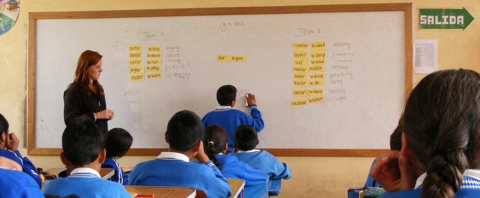A student finishes an English exercise on the white board at a volunteer teaching placement in Peru.