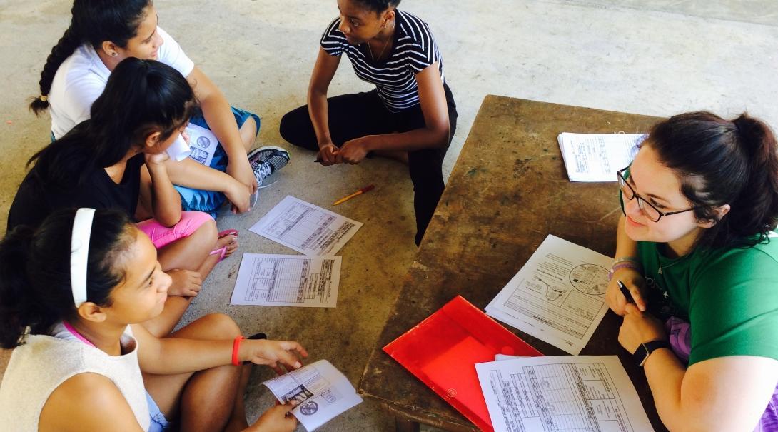 Local girls learn about the importance of healthy diets from a student doing a Nutrition internship abroad in Samoa.