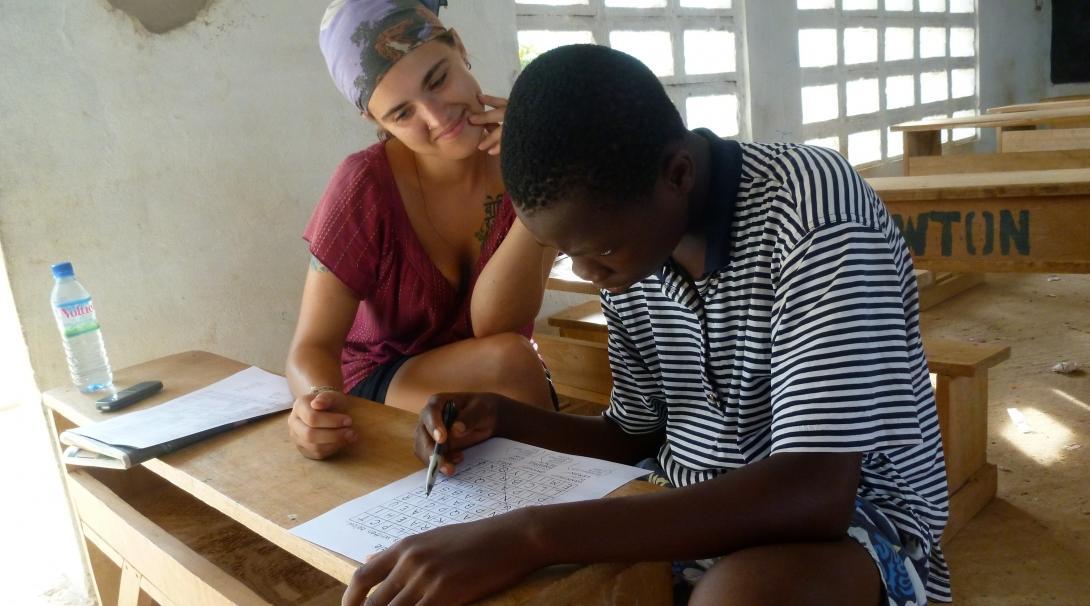 A young man participates in a therapy session run by a student doing a Speech Therapy internship in Africa.
