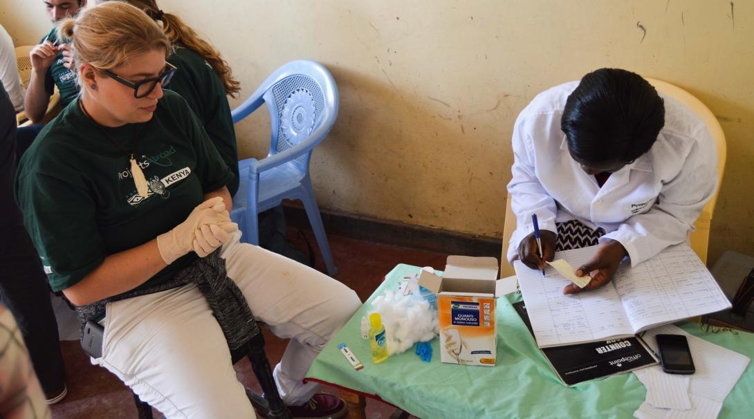 During a medical outreach, a pharmacy intern learns from observing a local pharmacist.