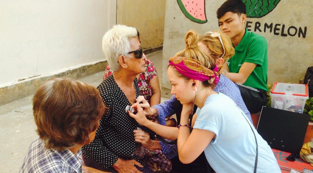 An intern is pictured conducting health screening as part of her public health internship in Cambodia.