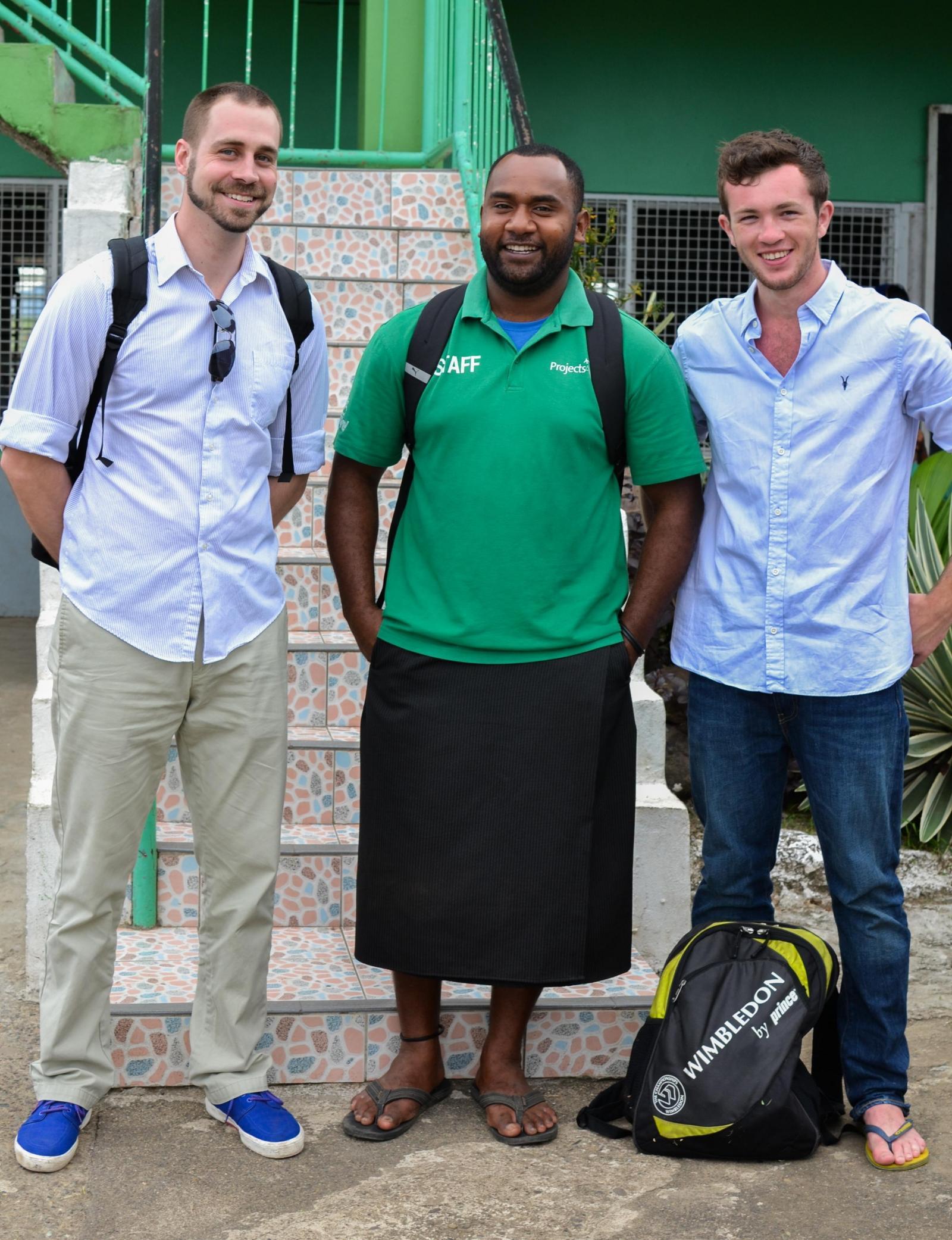 Projects Abroad volunteers pose for a photo with a staff member outside the placement in Fiji.