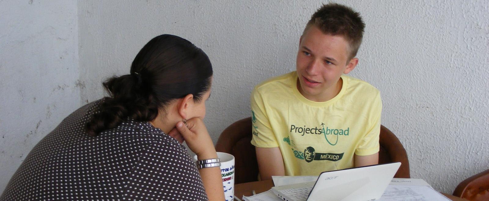 A young volunteer receives a Spanish language lesson as part of his induction at the Projects Abroad office.