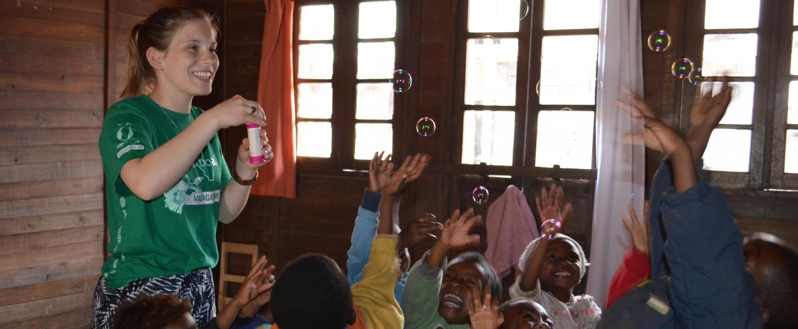 A Projects Abroad volunteer in Madagascar plays with the children after fundraising for her project.