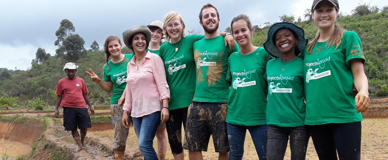 Projects Abroad volunteers after teaming up to help local farmers plant rice in Madagascar. 