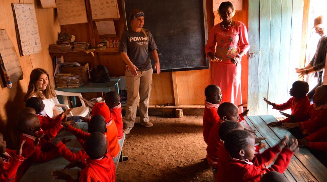 A Teaching volunteer supports a local teacher in a classroom in Kenya. 