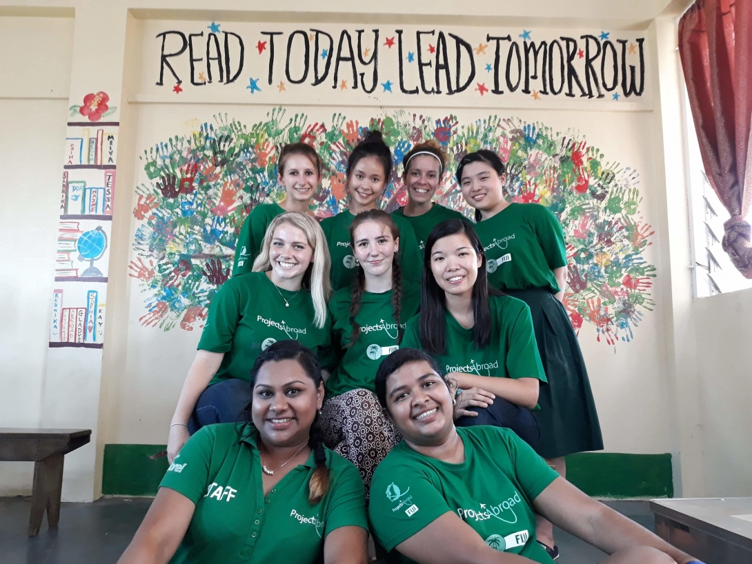 A group of high school volunteers joined to create a mural to promote literacy in our High School Special Childcare & Community Village project Fiji.