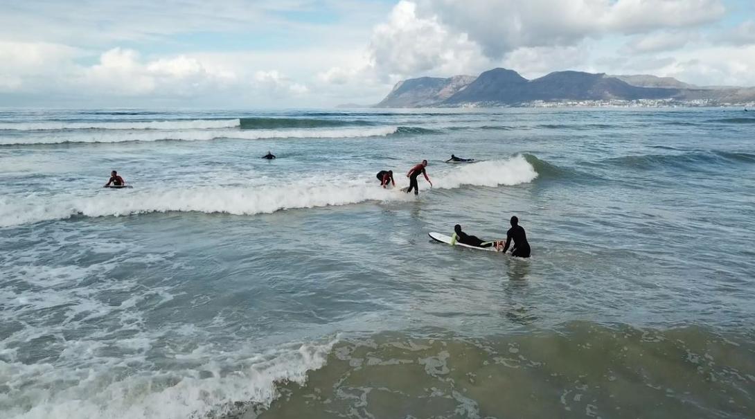 Shuan out in the water with the kids during surfing lessons