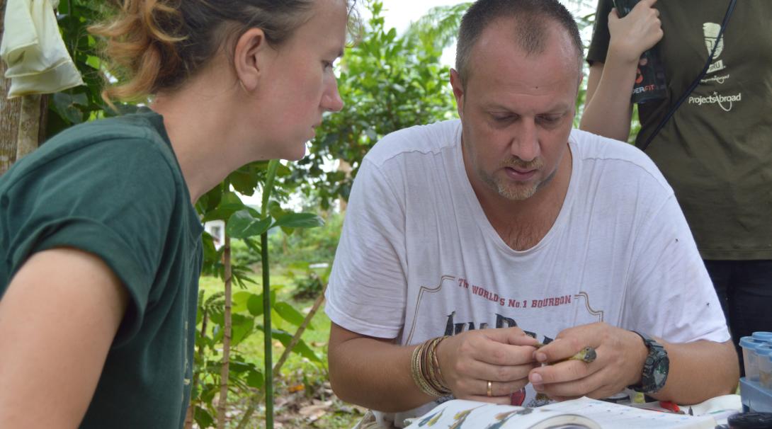 Stuart Timson helping a Conservation volunteer with one of her daily tasks