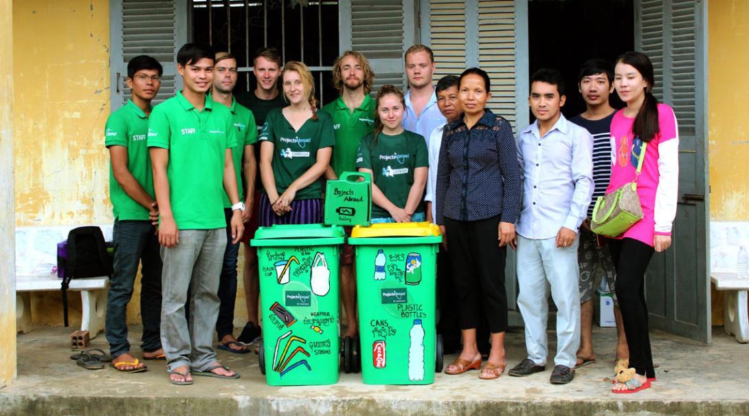 Volunteers and staff pose with the new recycle bins at a local school in Cambodia