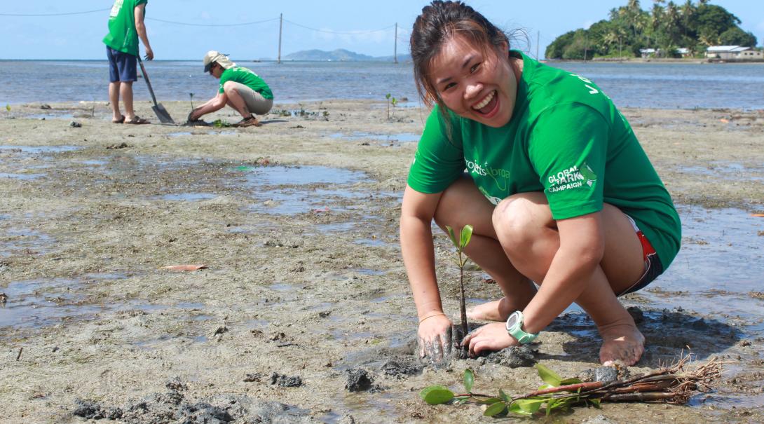 Projects Abroad Conservation volunteer plants a mangrove in Fiji