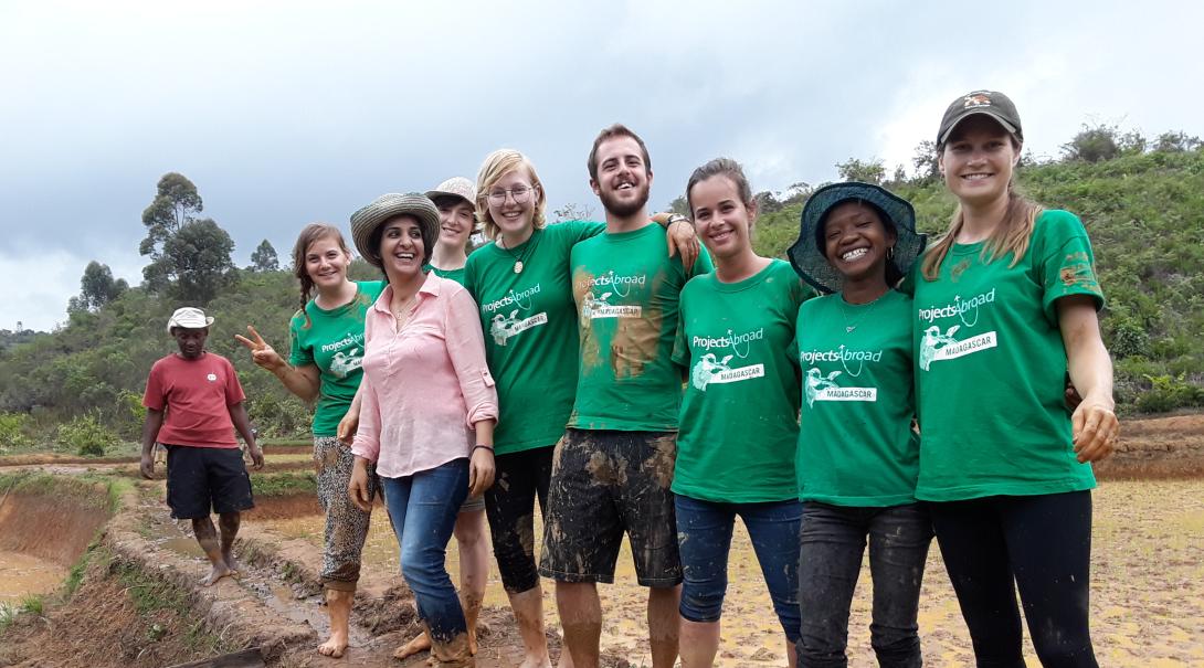 Volunteers take a group photo after their work day abroad in Madagascar