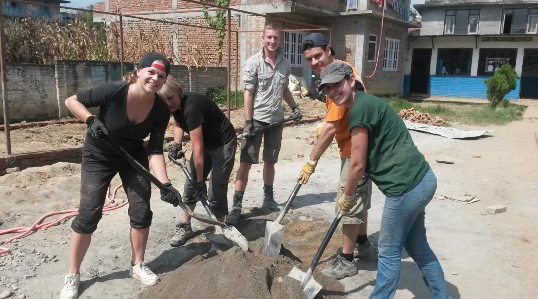 A group of volunteers dig foundations for a school at the 2015 Disaster Relief placement in Nepal
