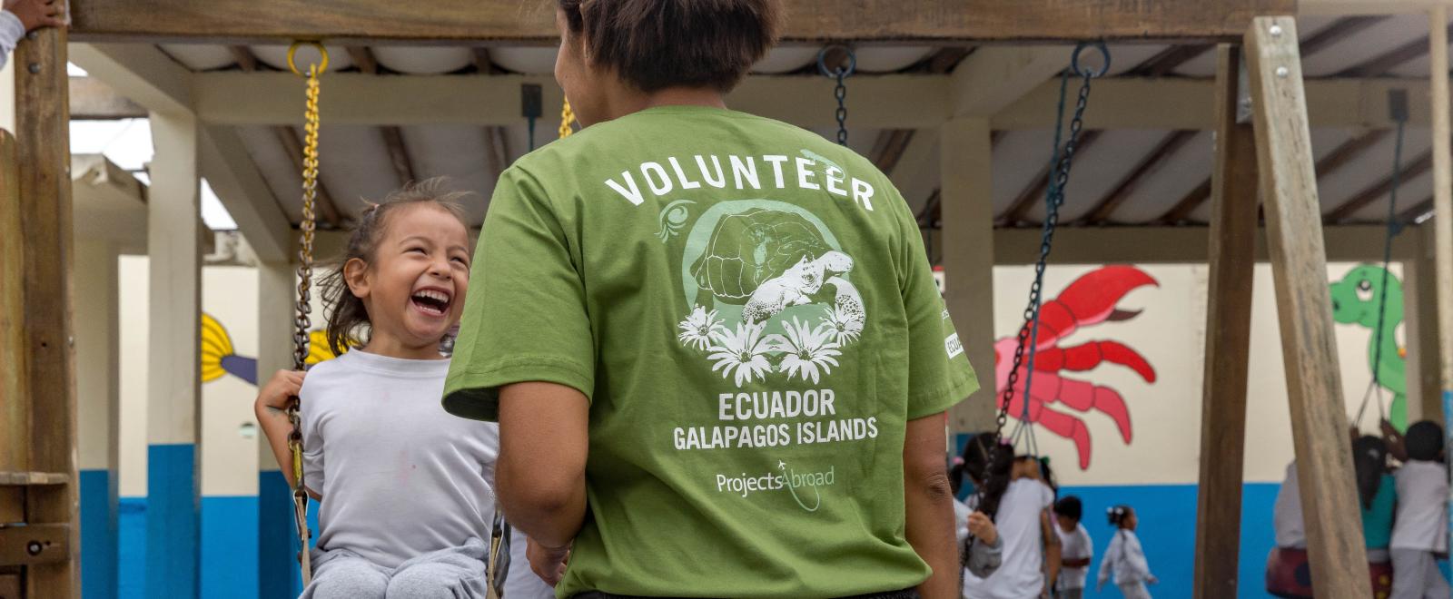 A childcare volunteer in Ecuador supervises children during playtime
