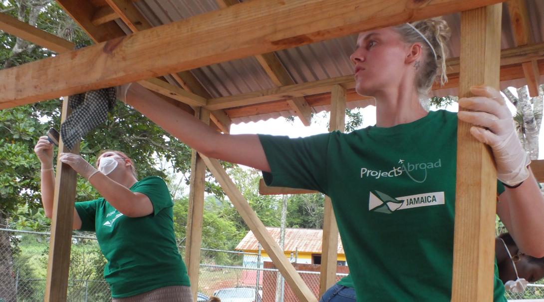 Projects Abroad volunteers add the final touches to a playground in Jamaica