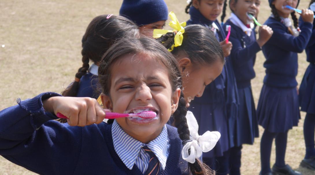 Projects Abroad volunteers work with children in Nepal and teach them the importance of brushing their teeth.