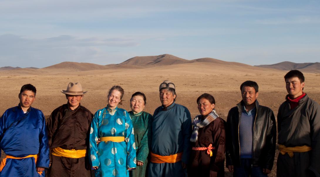 A volunteer takes a group photo with her host family in Mongolia during her cultural exchange program. 