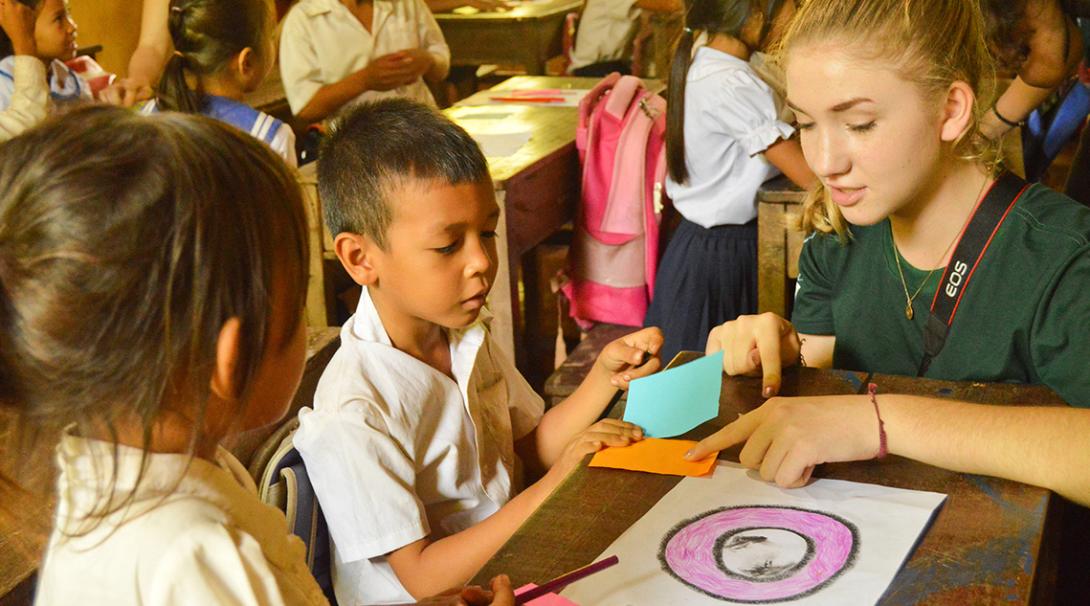 A volunteer working with children in Cambodia organises fun activities at a local community centre.