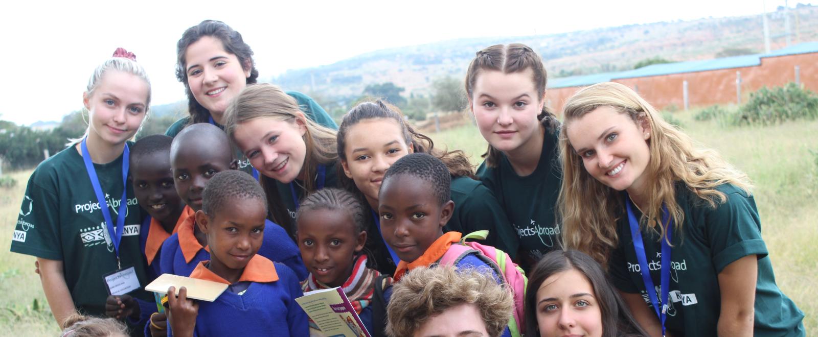 Healthcare volunteers take a group photo with students during a medical outreach in Kenya