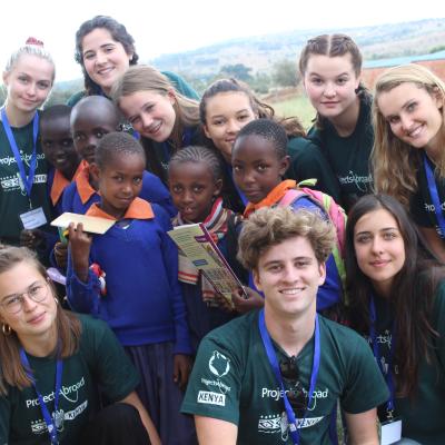 Healthcare volunteers take a group photo with students during a medical outreach in Kenya