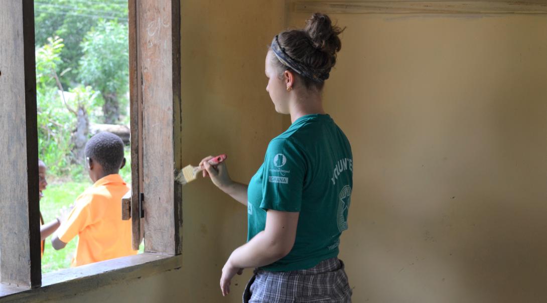  A high school student renovates a local school in Ghana during her community volunteer work for teenagers.
