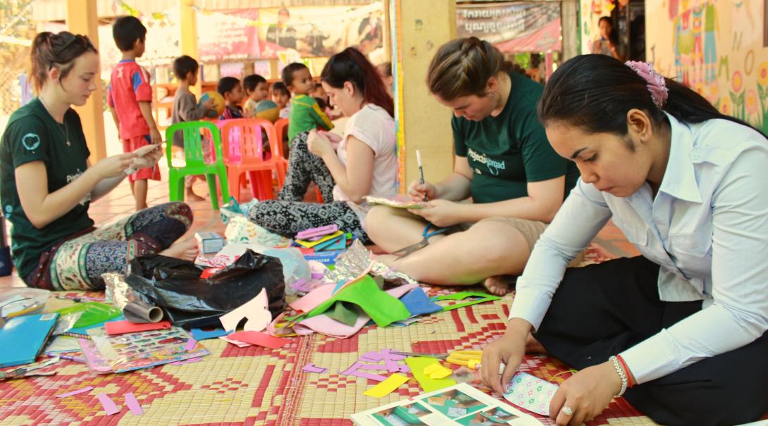 A group of High School Special volunteers is preparing an arts and crafts class for the local children during their care & community project in Cambodia.