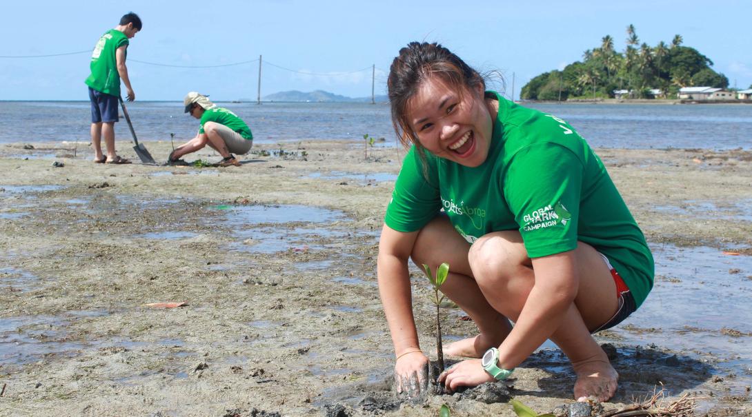 Projects Abroad volunteer plants mangroves as part of her Shark Conservation work in Fiji.