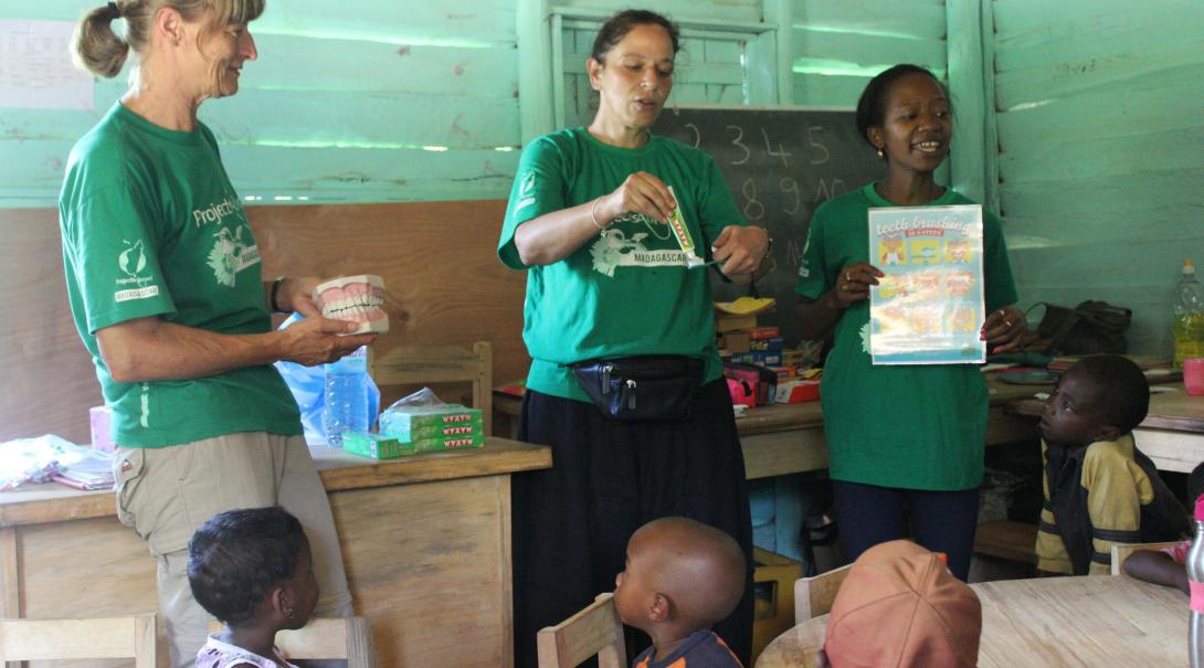 Older Projects Abroad volunteers teach a class to their students in Madagascar
