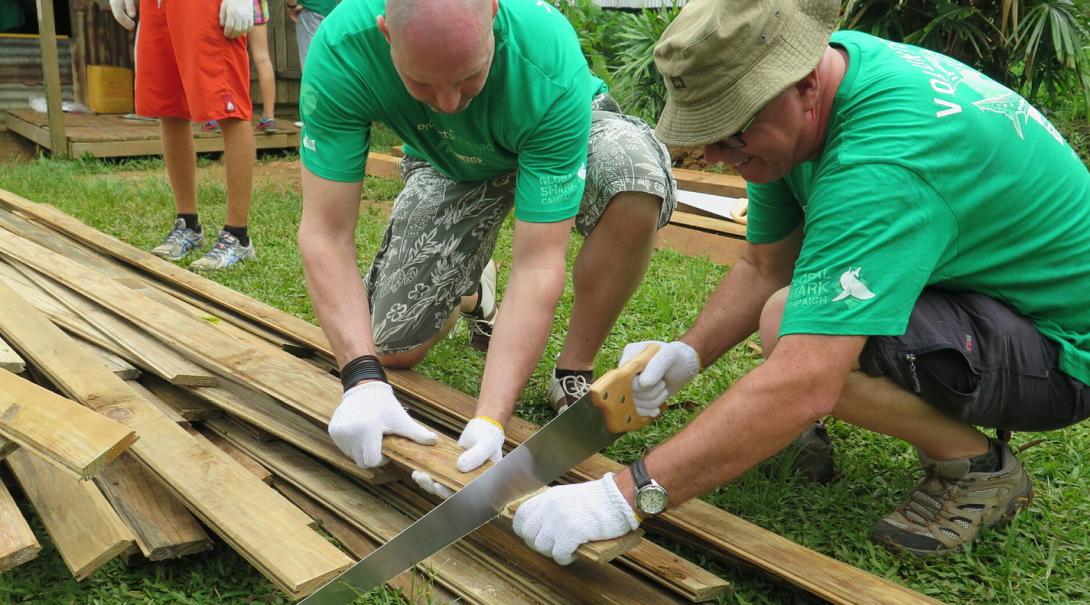 Retired professionals volunteer on a building project in Fiji