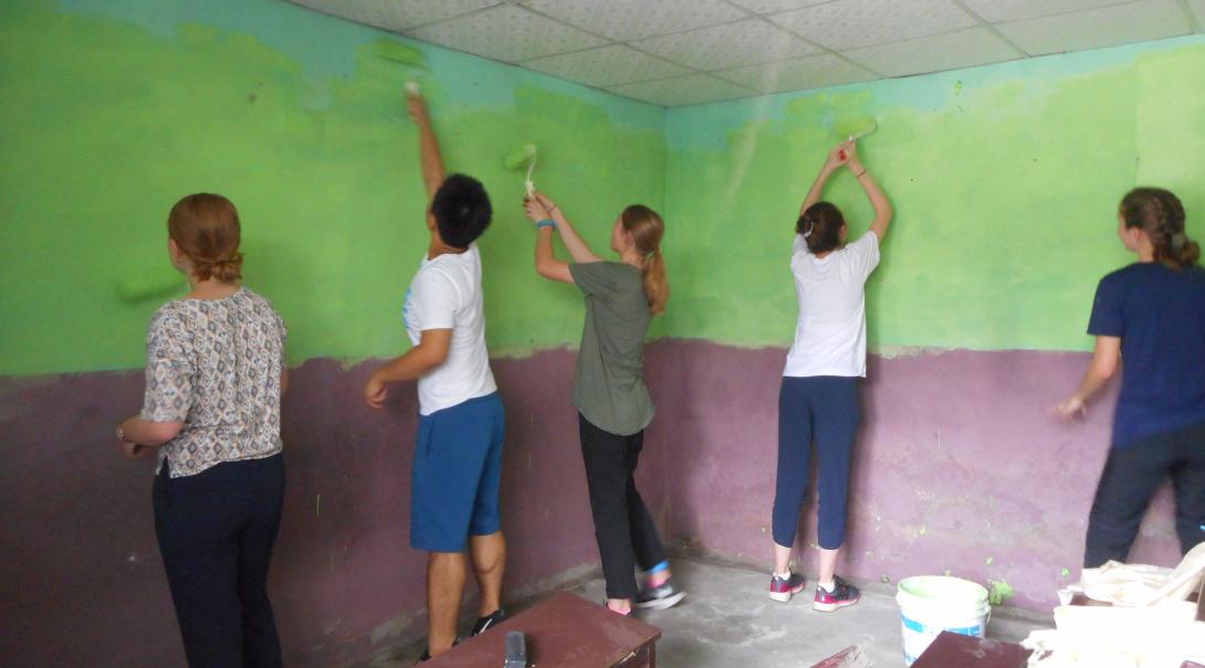 High School Special volunteers painting the walls of a classroom in Nepal
