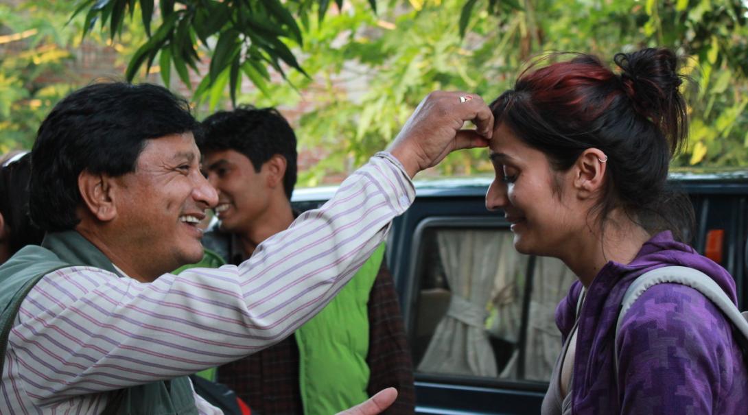 Projects Abroad volunteer gets welcomed by her host family in Nepal.