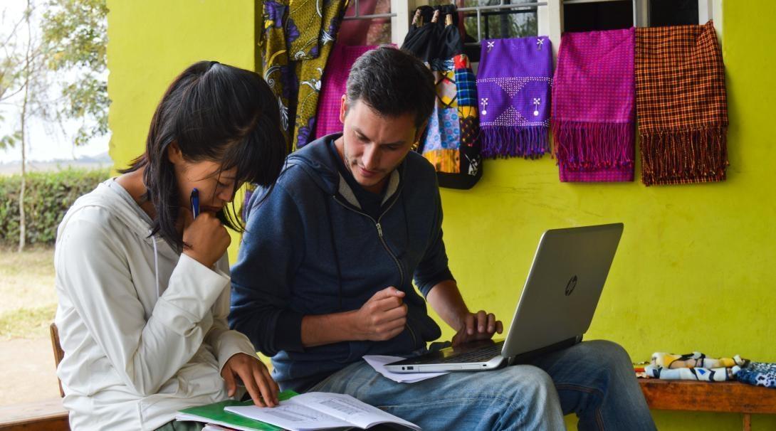 Projects Abroad volunteers enter data into the Global Impact Database while visiting a project