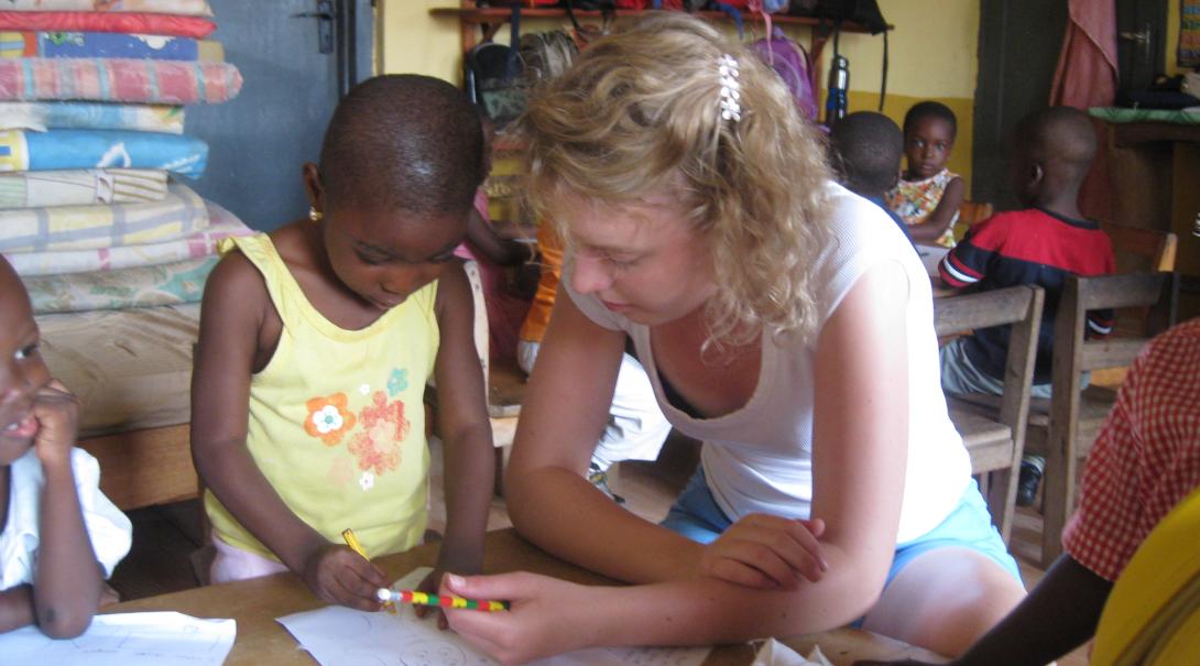 Projects Abroad volunteer observes her student while working with children in Ghana