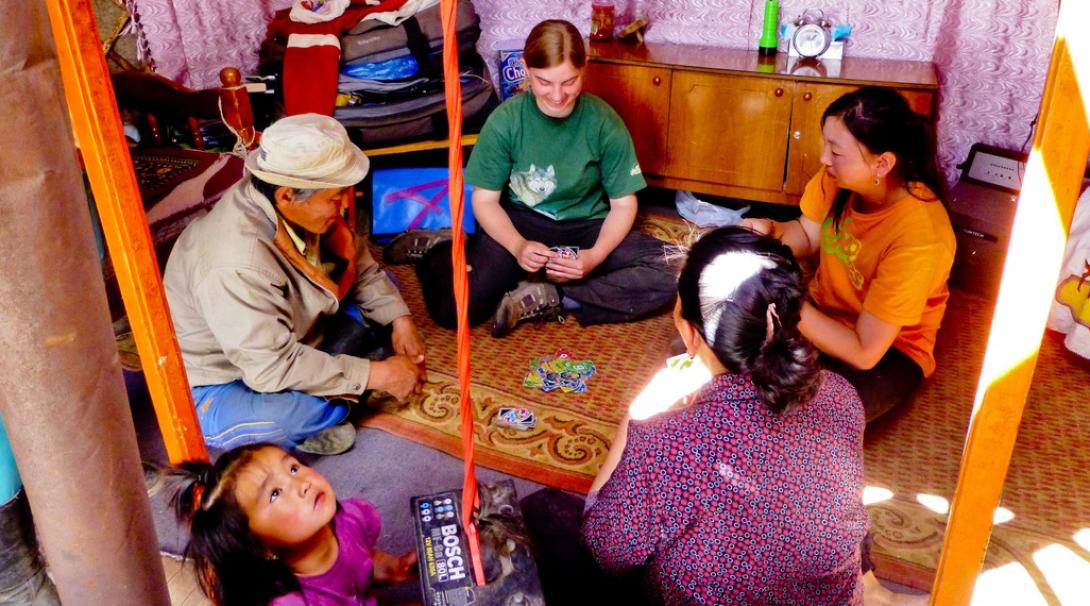 A Projects Abroad volunteer playing cards with her host family in Mongolia