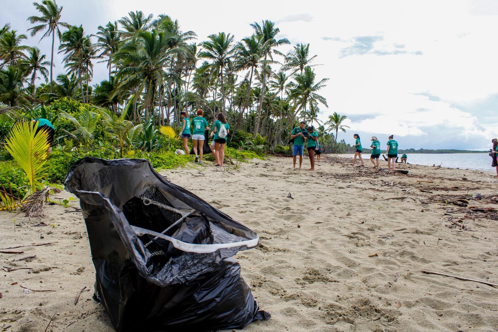 A group of volunteers participating in a beach clean up in Fiji, South Pacific. 