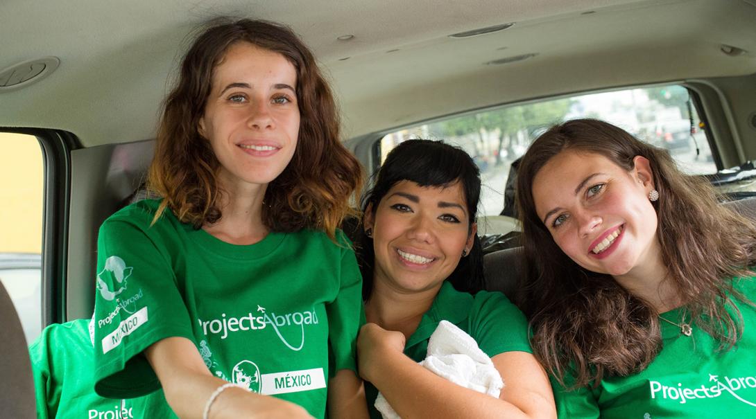 Refugees support volunteers in the back of a van on their way to their placement in Mexico.