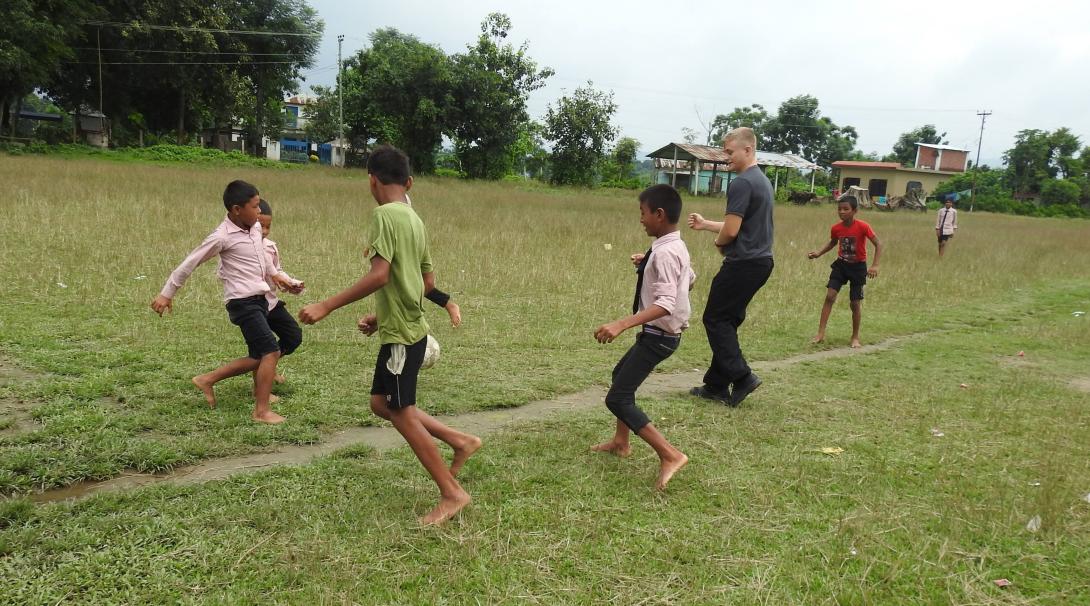Volunteer plays football with students at his Youth Empowerment Project in Nepal.