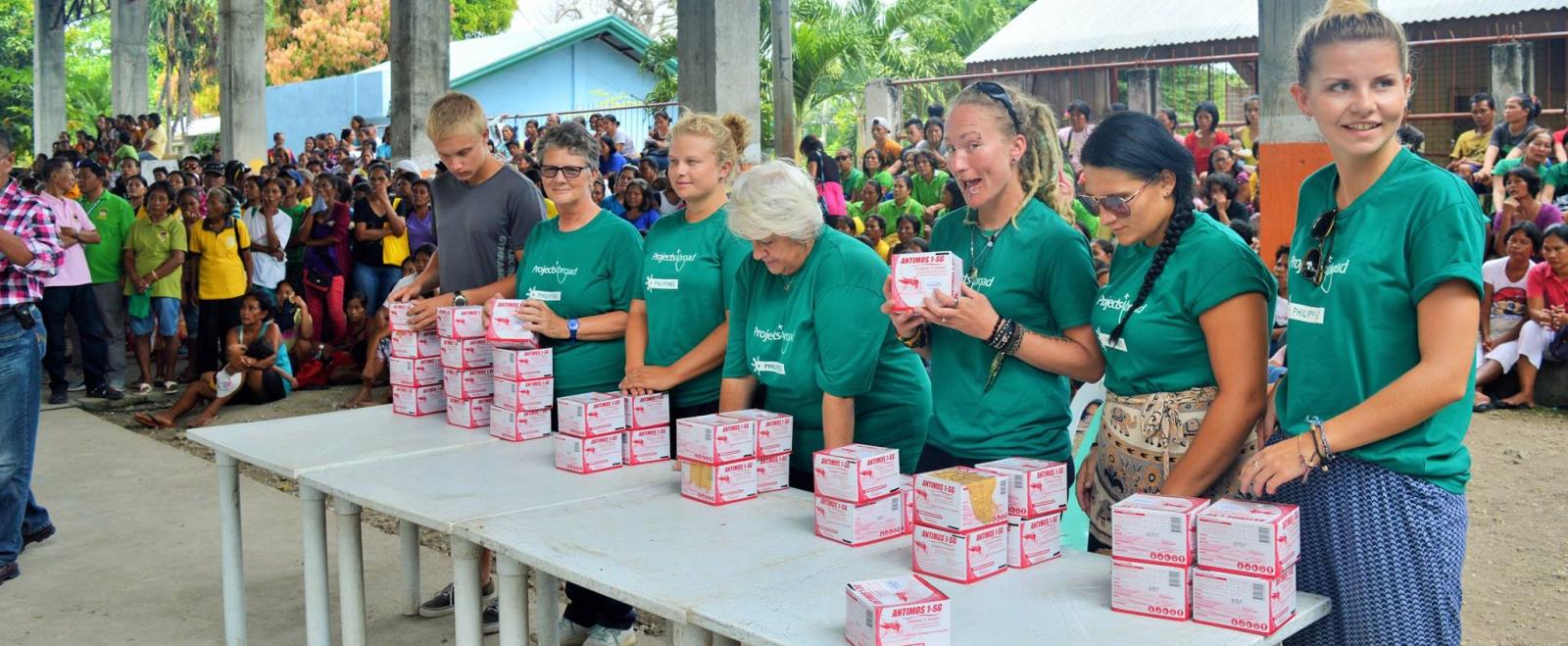 Medical volunteers hand out larvicide to prevent mosquitoes from breeding in the Philippines.