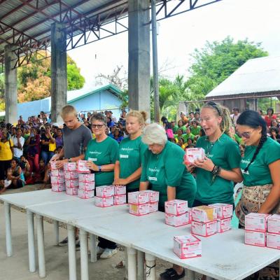 Medical volunteers hand out larvicide to prevent mosquitoes from breeding in the Philippines.