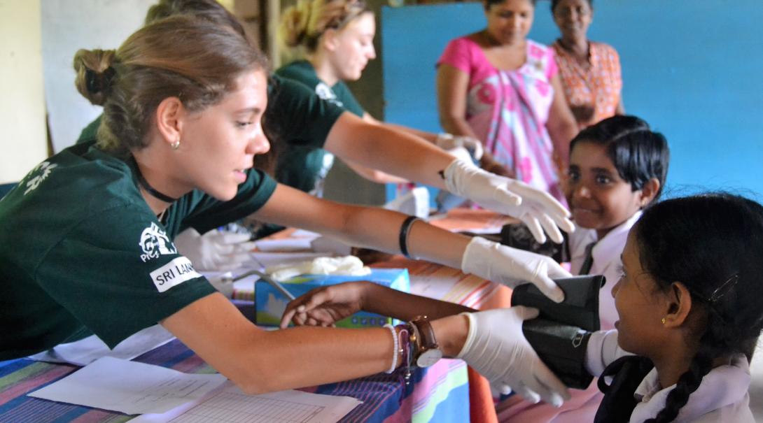 A group of high school students do basic health checks under supervision during their medical internship in Sri Lanka.