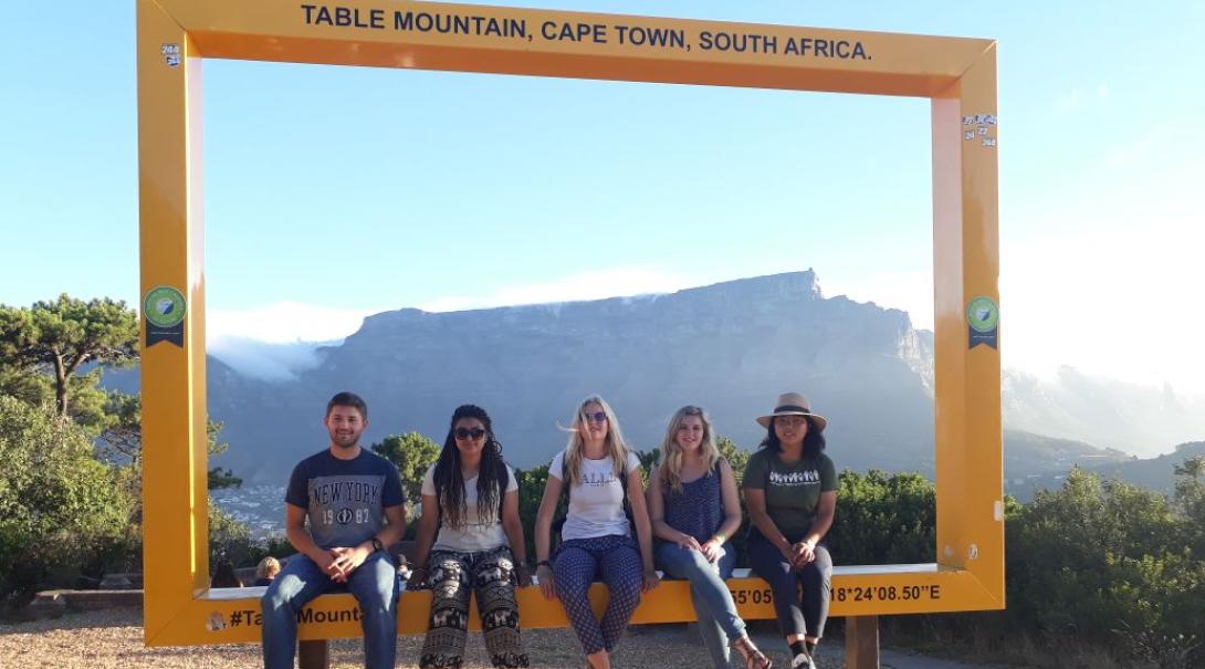 Projects Abroad volunteers taking a picture with unique bucket list destination Table Mountain in the background