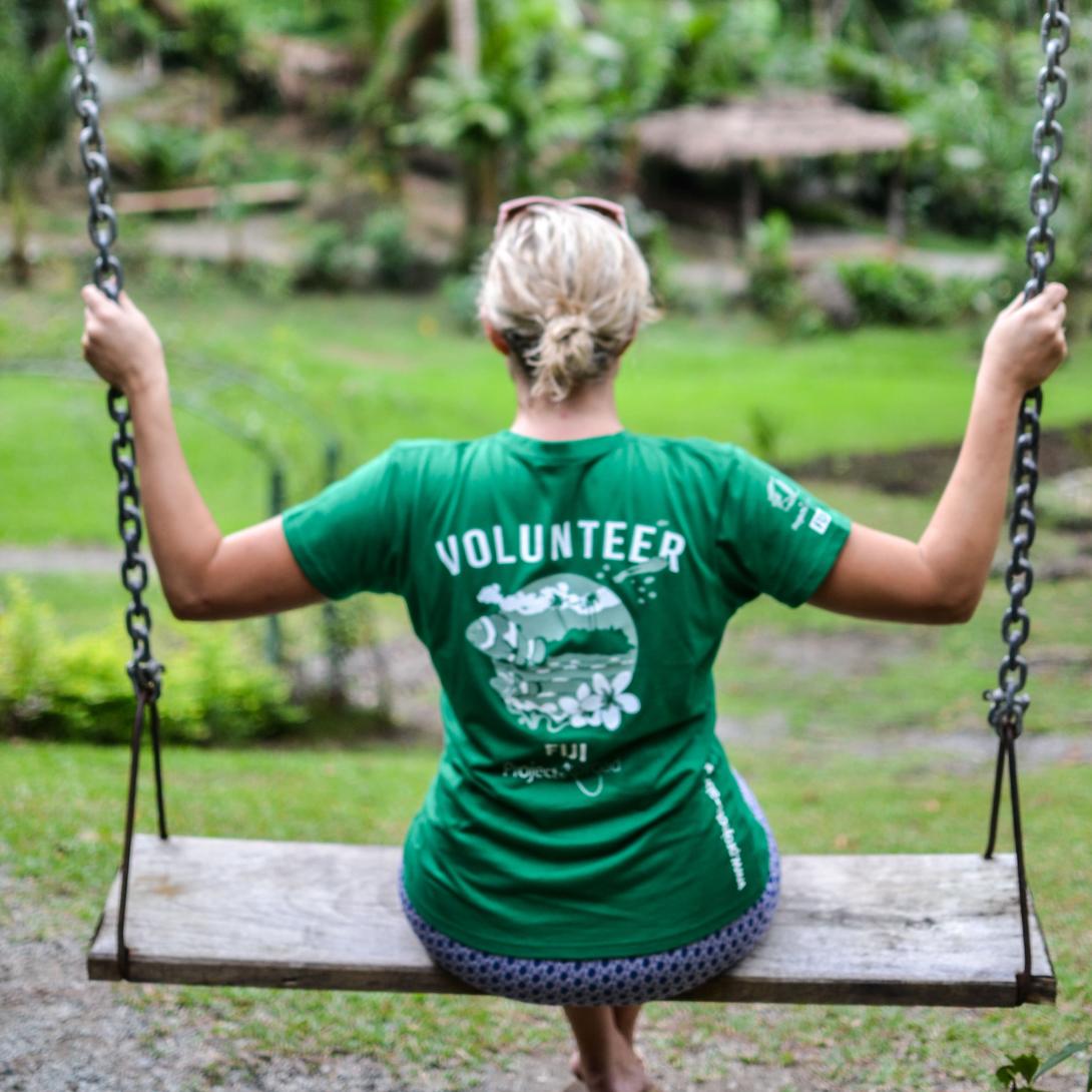 A Projects Abroad volunteer swinging in the Garden of Sleeping Giants, a bucket list destination in Fiji