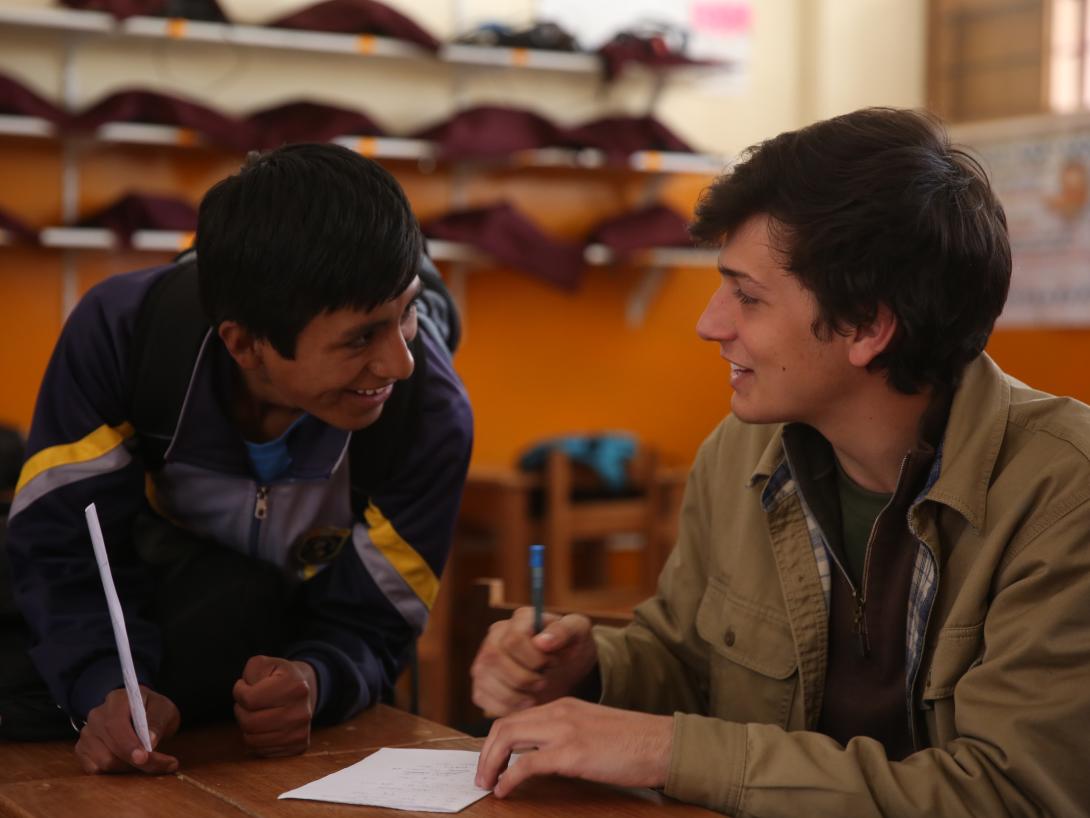A student in Peru on a Service Learning Program for college students works in a high school. 