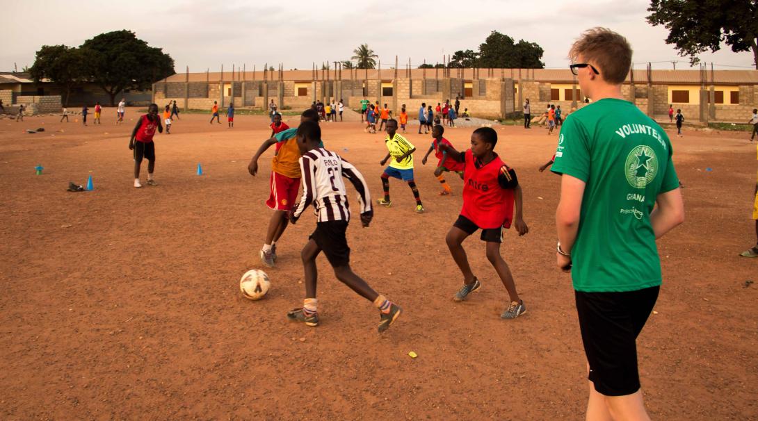 Projects Abroad High School Special volunteer referees a football match in Ghana during his Football Coaching project.