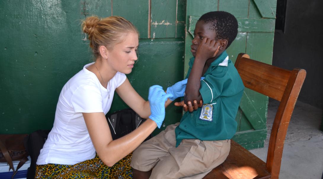 A volunteer runs a health check to a young boy in Ghana during her medicine project with Projects Abroad in Ghana.