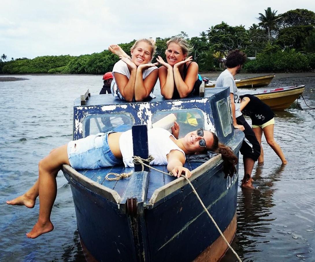 Projects Abroad volunteers relax on a boat during their free time in Fiji.