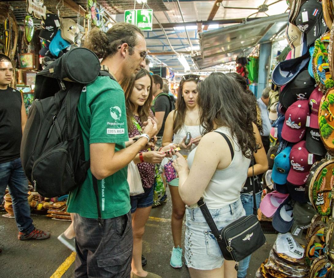 Gap year volunteer visits a market with other international volunteers in San Jose, Costa Rica.