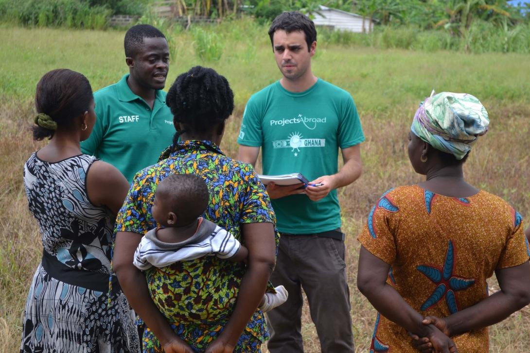 Projects Abroad volunteer doing a social work project in Ghana helps his supervisor doing field work.