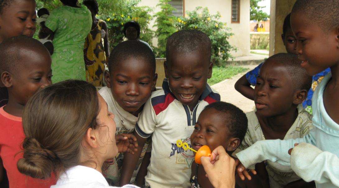 A social work volunteer plays with children and offers them support while doing her internship with Projects Abroad in Ghana.